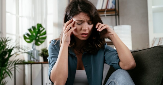 Upset woman on the phone wondering why her ex won't sign divorce papers